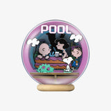 Glowing snow globe with cartoon characters and 'POOL' text on a white background