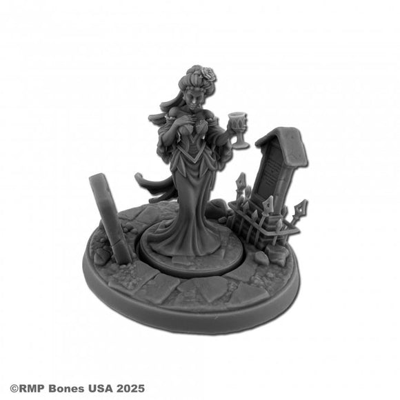 Gray miniature figurine of a vampire woman holding a goblet on a white background