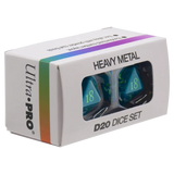 Ultra-PRO Heavy Metal D20 Dice Set in its original white packaging box, featuring a clear window showing two teal-colored heavy metal d20 dice inside.