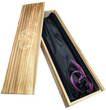 Wooden box with a black scroll bag inside on a white background