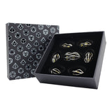 Set of gold and black dice in a black box with geometric patterned lid.