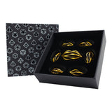 Set of gold dice in a black box with geometric patterned lid