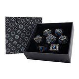 Set of metallic dice with blue engravings in a black box with geometric pattern
