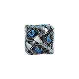 Silver decorative die with blue accents on a white background