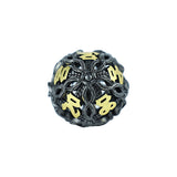 Decorative die with black and gold design on a white background