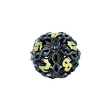 Decorative die with black and gold design on a white background