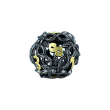 Decorative die with intricate designs and gold accents on a white background