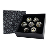 Set of decorative dice in a black box with geometric patterned paper
