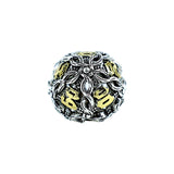Decorative die with silver and gold design on a white background