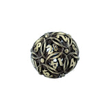 Decorative metal dice with intricate designs on a white background