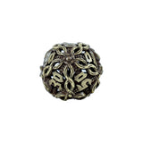Decorative metal die with intricate vine design on a white background