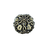 Decorative die with intricate design and numbers on a white background