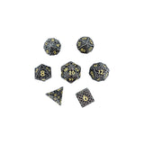 Set of black and gold polyhedral dice on a white background