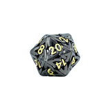 Black polyhedral dice with gold numbers on a white background