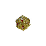 Gold intricate die with red numbers on a white background