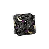 Black dice with gold and purple numbers on a white background
