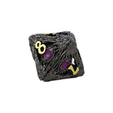 Black textured die with yellow and purple numbers on a white background