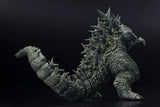 Toy figure of a large creature with spiky back on a black background