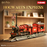 A 3D wooden puzzle of the Hogwarts Express train set on a wooden table with a blurred bookshelf background. The puzzle is branded with 'Harry Potter' and 'Puremind' logos.