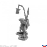 Gray miniature figurine of a warrior with a spear on a white background