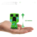 A small green Minecraft Creeper toy figure is shown resting on an open hand, with a green arrow and text indicating its height is 3.5 inches.