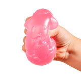 Hand holding a pink silicone dog-shaped product on a white background