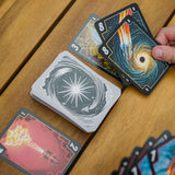 Playing cards with space-themed designs on a wooden surface