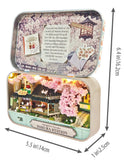 A miniature sakura blossom diorama set inside an open metal tin box, shown with dimension arrows and labels indicating 6.4 in height, 5.