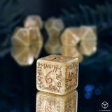 A set of beige polyhedral gaming dice with brown mystical script and a large red '6' on the front, displayed on a reflective dark surface with other blurred dice in the background.