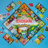 Monopoly Pokémon board game with various cards and pieces on a blue background