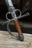 Decorative sword with a brown handle on a wooden surface