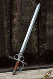 Decorative sword with a detailed hilt on a wooden surface and dark wooden background