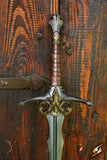 Decorative sword with ornate hilt on a wooden background