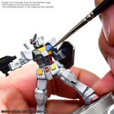 Model kit of a robot being assembled with a screwdriver on a white background
