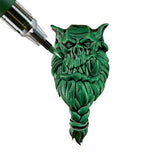 Green gargoyle head with a screwdriver on a white background