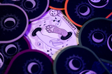 Card with 'Shapeshift' design surrounded by circular purple designs on a dark background