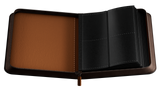 Open leather card binder with brown interior and black exterior on a white background
