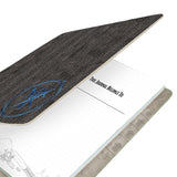 Journal with textured black cover and visible text on white background
