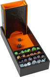 Collection of dice in a black and orange dice box with a dragon design.