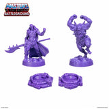 Two purple action figures with accessories on a white background, featuring 'Masters of the Universe Battleground' logo.