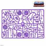 Purple plastic sheet with miniature figures and parts, featuring 'Masters of the Universe Battleground' branding.