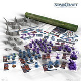 StarCraft tabletop miniature game set with various units, cards, and scenery on a white background.