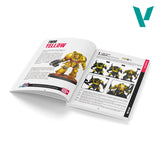 Open book showing a toy figure with yellow and black design on a white background