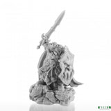 Gray miniature figurine with armor and spear on a white background