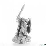 Gray warrior figurine with a sword and shield on a white background