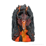 Dragon head sculpture emerging from volcanic rock on a white background