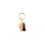 Gold keychain with a round pendant on a white background