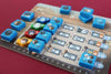 Board game piece set on a wooden board with various symbols