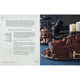 Chocolate cake with skulls on a plate next to text on a white background