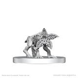 White figurine of a creature with star-like head on a white background